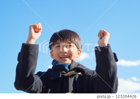 青空のもとガッツポーズをする少年 青空のもとガッツポーズをする少年 123204426