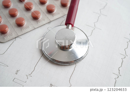 Stethoscope on electrocardiogram ECG, heart wave, heart attack, cardiogram report. Stethoscope on electrocardiogram ECG, heart wave, heart attack, cardiogram report. 123204633