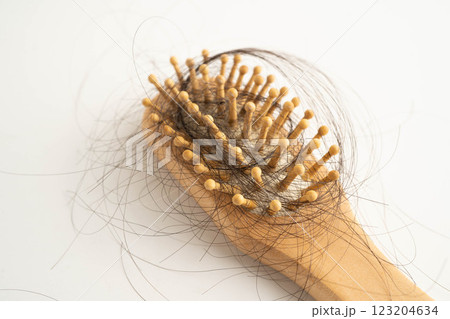 Hair loss fall with comb brush isolated on white background. Hair loss fall with comb brush isolated on white background. 123204634