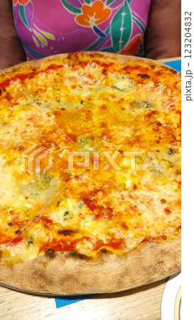 Melted mozzarella, gorgonzola, provolone, parmesan covering crispy pizza crust in rustic italian restaurant, bibione Melted mozzarella, gorgonzola, provolone, parmesan covering crispy pizza crust in rustic italian restaurant, bibione 123204832