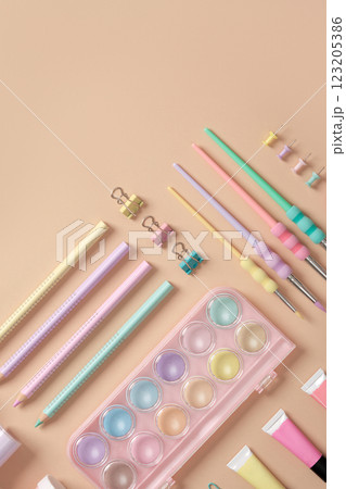 Banner with drawing supplies in green, yellow, pink and purple pastel colors on beige background. Space for your text. Banner with drawing supplies in green, yellow, pink and purple pastel colors on beige background. Space for your text. 123205386