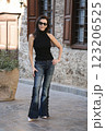 Attractive woman age model 51 years old posing in fashionable jeans with beads in the Old Town in Antalya Turkey 123206525