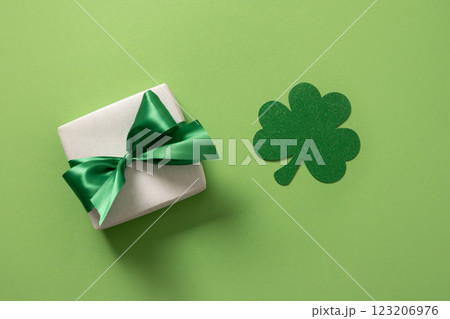 St Patricks day and March 17 concept with gift and clover leaf on green background. View from above. 123206976
