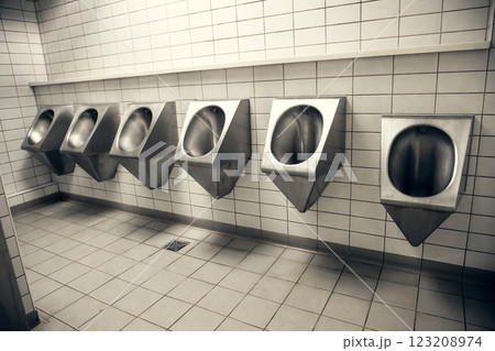 Row of stainless steel urinals in a public restroom. Modern and industrial bathroom design with Row of stainless steel urinals in a public restroom. Modern and industrial bathroom design with 123208974