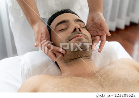 Caucasian man enjoying relaxing anti-stress head massage. Quiescent 123209625