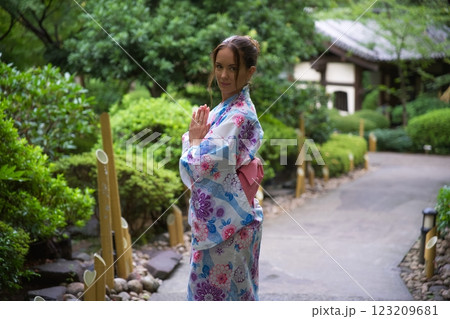 Elegant Woman in Kimono Practicing Mindfulness in Garden  123209681