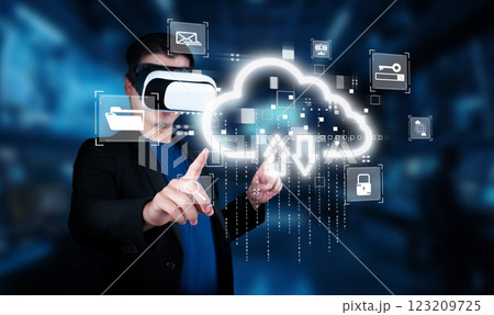 Person in Virtual Reality Headset Interacting with Cloud Computing Interface and Data Symbols in Modern Digital Environment XDMCP 123209725