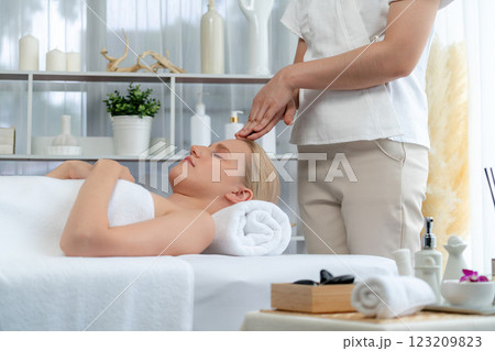 Caucasian woman enjoying relaxing anti-stress head massage. Quiescent Caucasian woman enjoying relaxing anti-stress head massage. Quiescent 123209823