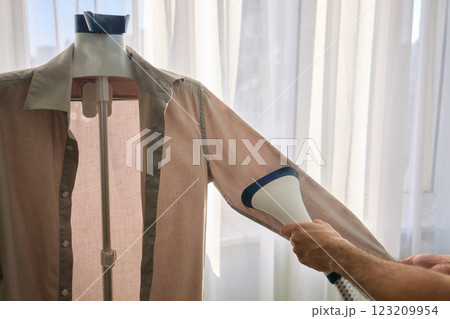 Steam cleaning your garments ensures a crisp, polished finish that enhances their appearance 123209954