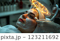 A woman is enjoying a facial treatment at a beauty salon 123211692