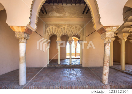 Alcazaba, palace and fortification in Malaga city at Andalusia, Spain, Europe. Ornate arches and columns in a historic building. Intricate details and warm light create a serene atmosphere. 123212104