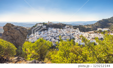 Casares town in Andalusia, Spain, Europe. Whitewashed village nestled in a hillside, overlooking a vast valley under a clear blue sky. 123212144