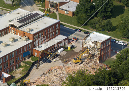 Demolition of Historic Edwards Building in Berea, Kentucky. Crawler excavator demolishing brick walls of old structure Demolition of Historic Edwards Building in Berea, Kentucky. Crawler excavator demolishing brick walls of old structure 123213793