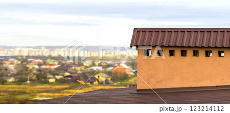 Chimney on a roof of a new built house with view of a city below 123214112
