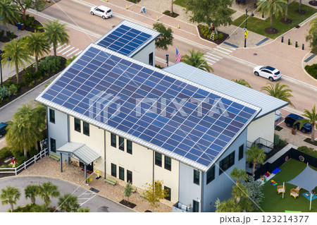 Autonomous building in Florida with photovoltaic rooftop covered with solar panels for producing of clean ecological electrical energy in town center Autonomous building in Florida with photovoltaic rooftop covered with solar panels for producing of clean ecological electrical energy in town center 123214377