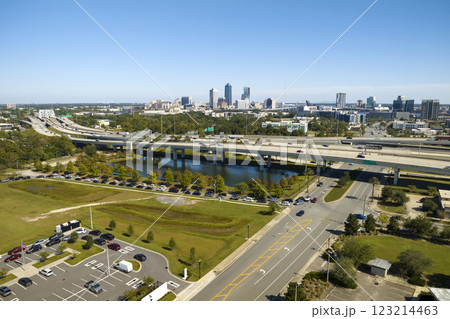 Aerial view of Jacksonville city with high office buildings and american freeway intersection with fast driving cars and trucks. View from above of USA transportation infrastructure Aerial view of Jacksonville city with high office buildings and american freeway intersection with fast driving cars and trucks. View from above of USA transportation infrastructure 123214463
