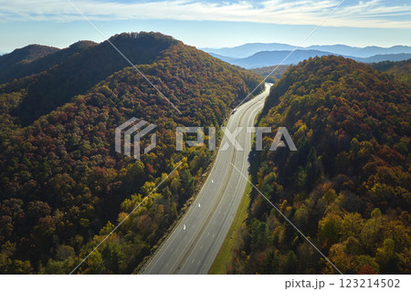Aerial view of empty I-40 freeway in North Carolina leading to Asheville through Appalachian mountains in golden fall season. Interstate transportation concept Aerial view of empty I-40 freeway in North Carolina leading to Asheville through Appalachian mountains in golden fall season. Interstate transportation concept 123214502