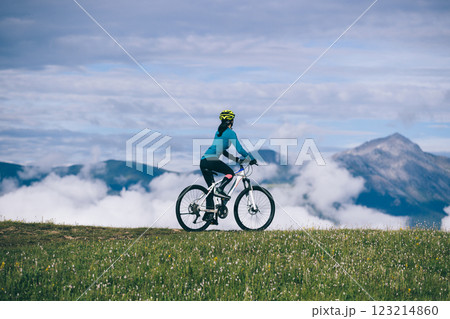 Riding mountain bike on beautiful mountain top Riding mountain bike on beautiful mountain top 123214860