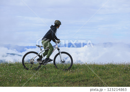 Riding mountain bike on beautiful mountain top 123214863