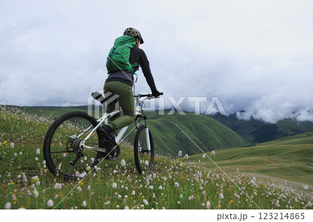 Riding mountain bike on grassland mountain top 123214865