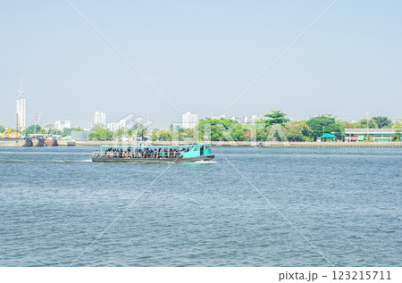 Boat on calm water with distant cityscape background Boat on calm water with distant cityscape background 123215711