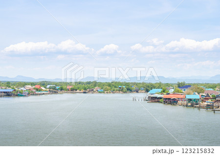 Serene waterfront with colorful houses and mountains. 123215832