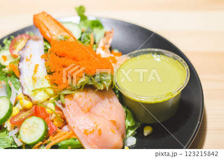 Fresh seafood wasabi salad with colorful toppings and dressing. 123215842