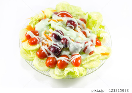 Fresh salad with tomatoes and dressing on a plate Fresh salad with tomatoes and dressing on a plate 123215958
