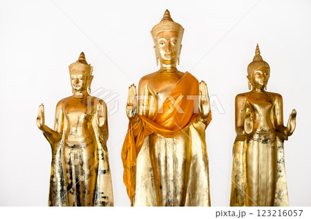 Three golden Buddha statues with orange robes at Wat Pho Bangkok Thailand Three golden Buddha statues with orange robes at Wat Pho Bangkok Thailand 123216057