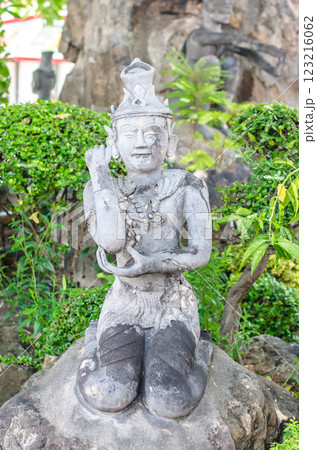 Stone statue surrounded by greenery at Wat Pho Bangkok Thailand 123216062