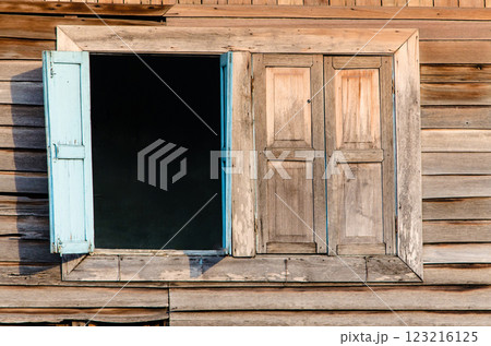 Open wooden window with weathered shutters Open wooden window with weathered shutters 123216125