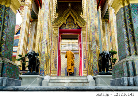 Ornate temple entrance with a monk walking in Wat Ratchabophit Bangkok Thailand Ornate temple entrance with a monk walking in Wat Ratchabophit Bangkok Thailand 123216143