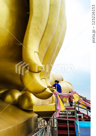 The woman is praying the Great Buddha of Thailand, Big Buddha at Wat Muang temple Angthong, Thailand 123216153