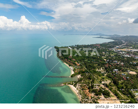 Scenic coastline with lush green landscapes and clear turquoise sea under a cloudy sky. Koh Samui, Thailand. Scenic coastline with lush green landscapes and clear turquoise sea under a cloudy sky. Koh Samui, Thailand. 123216240