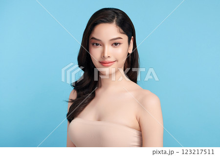 Beautiful Young transgender woman with clean fresh skin on blue background, Face care, Facial treatment, Cosmetology, beauty and spa, transgender women portrait. Beautiful Young transgender woman with clean fresh skin on blue background, Face care, Facial treatment, Cosmetology, beauty and spa, transgender women portrait. 123217511
