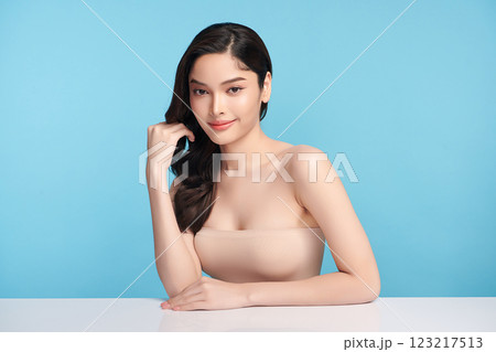 Beautiful Young transgender woman with clean fresh skin on blue background, Face care, Facial treatment, Cosmetology, beauty and spa, transgender women portrait. Beautiful Young transgender woman with clean fresh skin on blue background, Face care, Facial treatment, Cosmetology, beauty and spa, transgender women portrait. 123217513