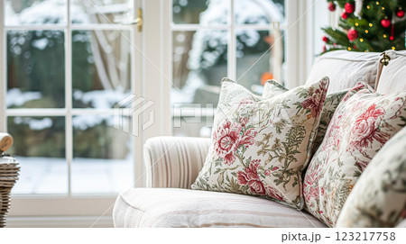 Colorful pillows on sofa against glass wall of window in a winter garden or conservatory. Interior textile concept. High quality photo 123217758