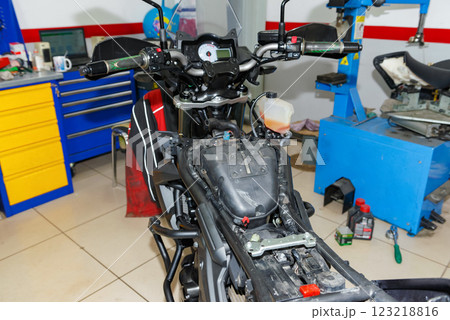 The master performs maintenance on the motorcycle. The master performs maintenance on the motorcycle. 123218816