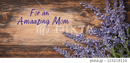 Rustic Mothers Day Card Design with Handwritten Text and Lavender Sprigs on Wooden Background 123219110