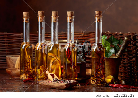 Bottles of olive oil with various spices and vintage cooking utensils. 123222328