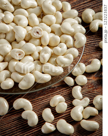 Cashew nuts in milk chocolate on a brown wooden background. Close-up. Cashew nuts in milk chocolate on a brown wooden background. Close-up. 123223837