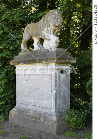 Sculpture of a lion with his paw placed on a sphere in Chantilly 123224229