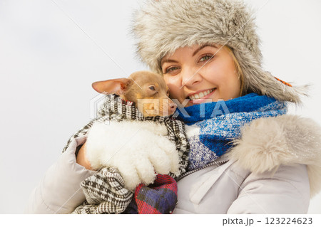 Woman hug warming her dog in cold day Woman hug warming her dog in cold day 123224623