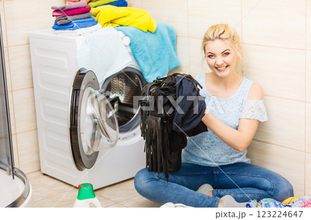 Woman about to do laundry Woman about to do laundry 123224647