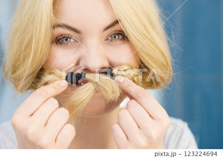 Woman making moustache braided hair Woman making moustache braided hair 123224694