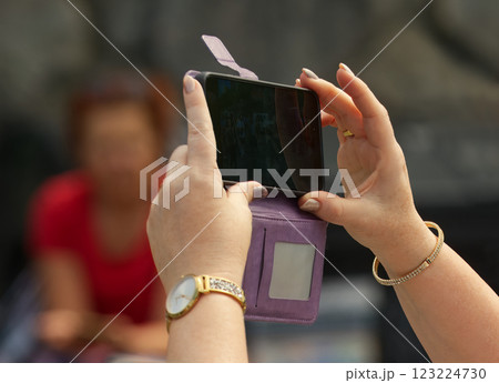 Hands Holding Smartphone Taking a Picture Outdoors with Blurred Background 123224730