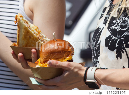 A woman holding paper tray with sweet dessert. A woman holding paper tray with sweet dessert. 123225195