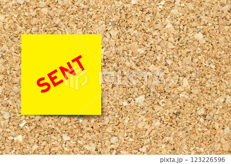 Yellow note paper with word sent on cork board background with copy space 123226596