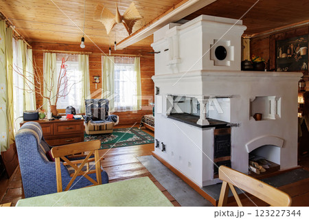Traditional Russian Stove in Cozy Wooden House Interior 123227344