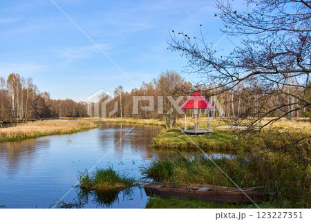 Autumn Day River Scene with Red Gazebo and Old Boat Autumn Day River Scene with Red Gazebo and Old Boat 123227351